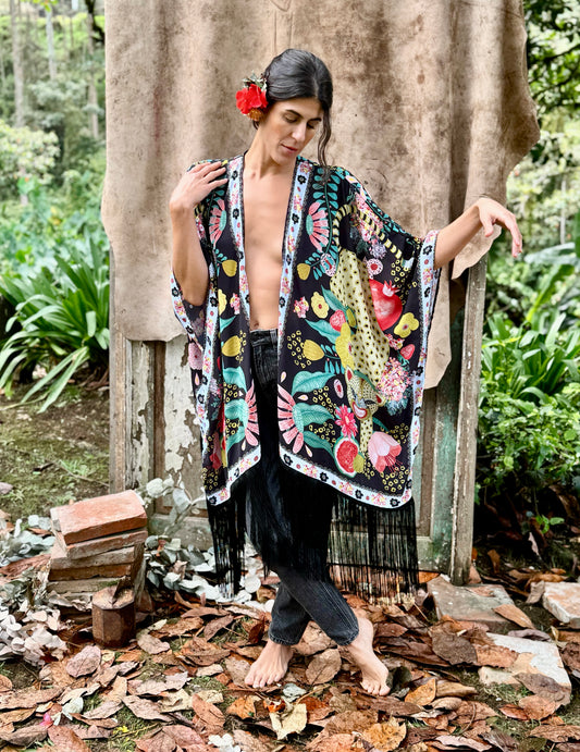 Front view of TelaCuento kimono opened to reveal its colourful illustrated pattern and flowing chiffon silhouette